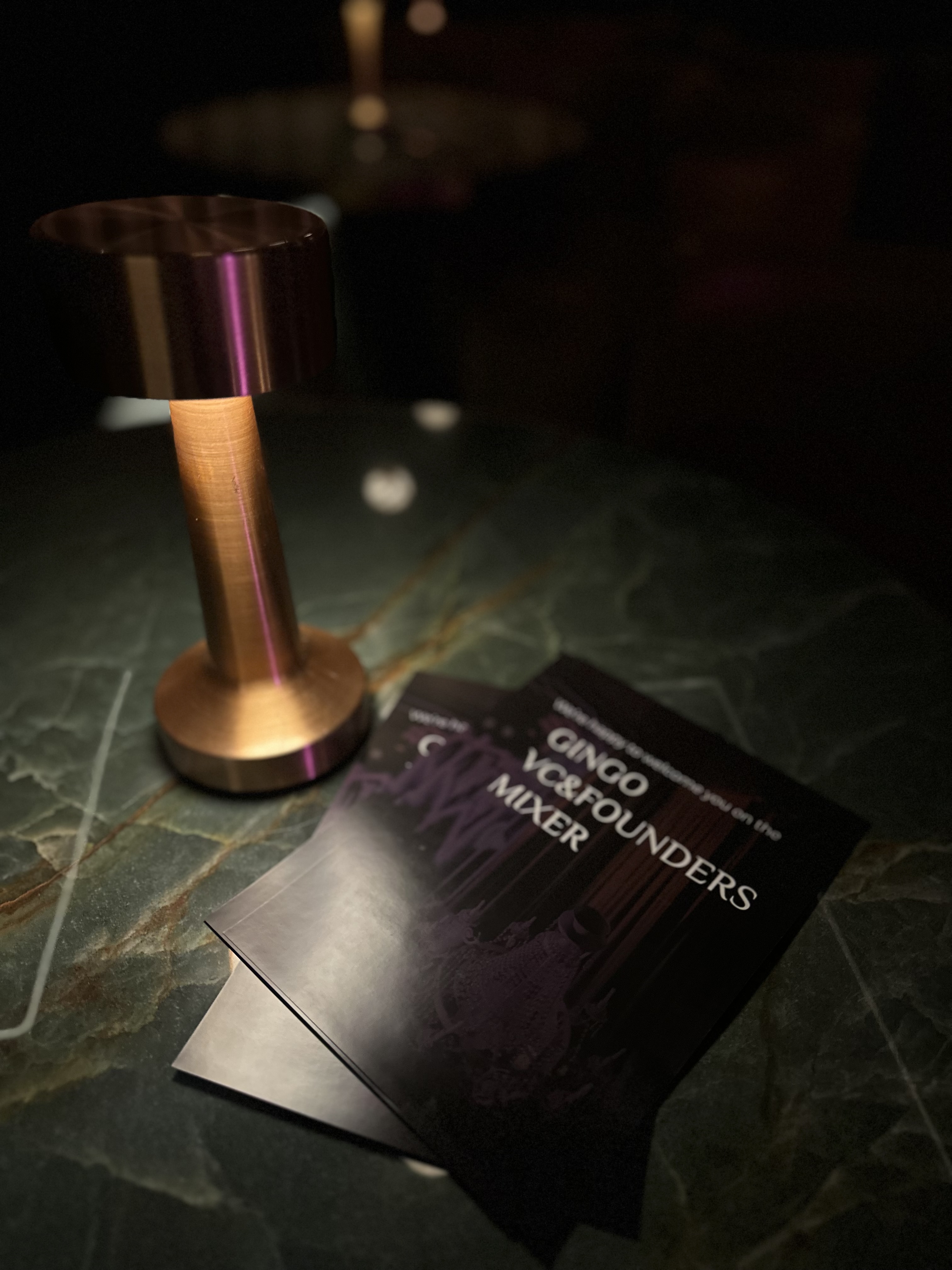 Table lamp and invitations at a Step Conference side event